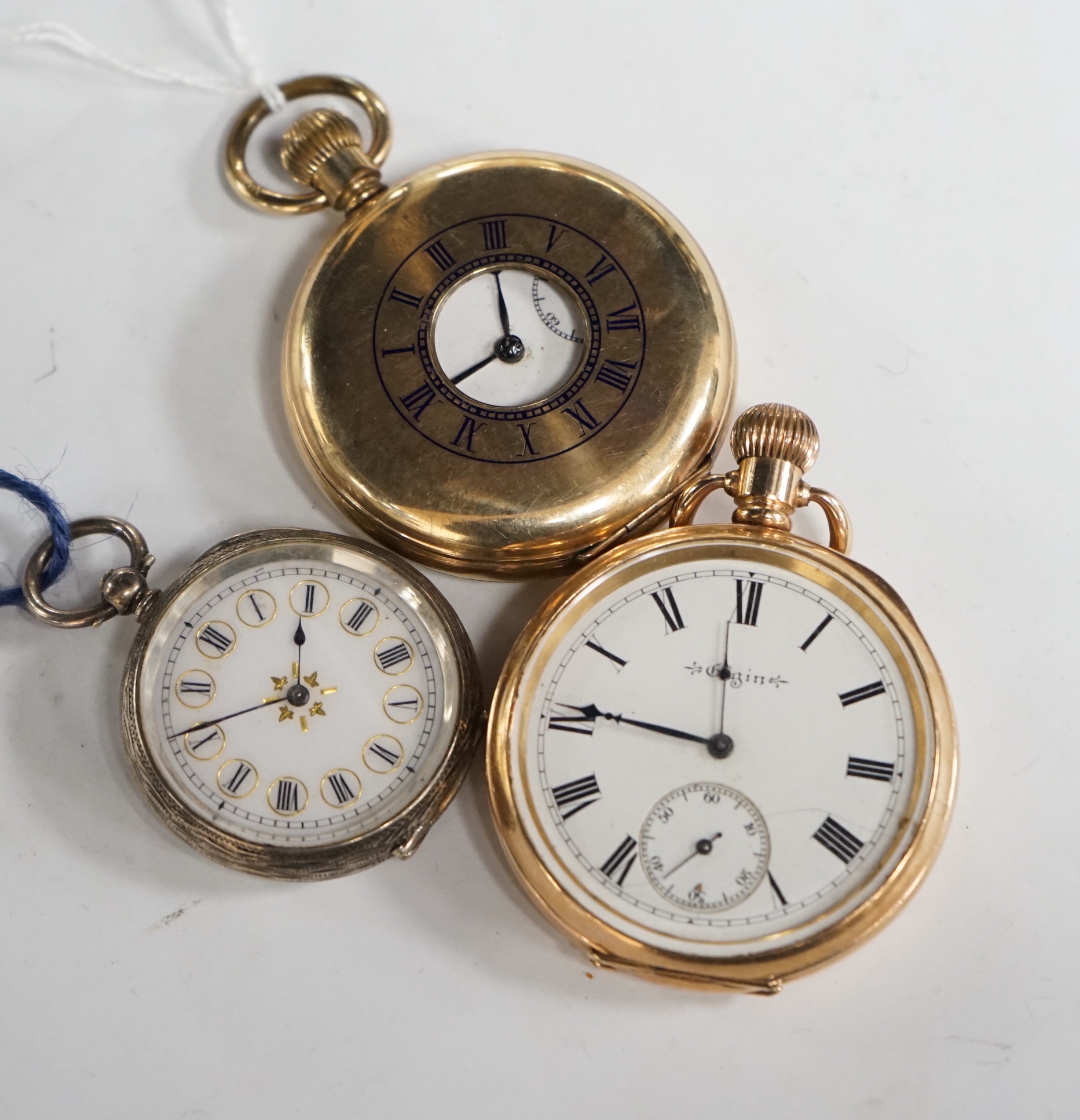 A continental engraved 935 white metal open face fob watch, together with an Elgin gold plated open face pocket watch and a gold plated half hunter pocket watch.